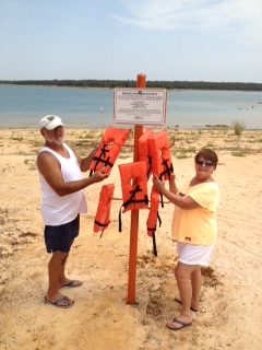 Ron Fields and Debbie Felgenhauer filling the life jacket holders at the beach/swim area near Lake Murray Marina.